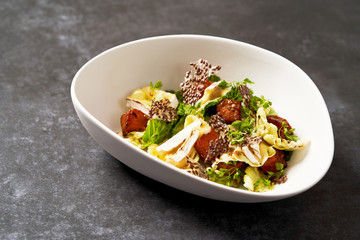 Baked Pumpkin salad with baked cheese, parsley herbs, white cabbage