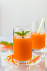 Freshly squeezed carrot juice with celery, vertical orientation