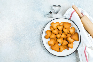 Plate with sweet cookies for Valentines day. Shortbread cookies in shape of heart. Top view, flat lay, copy space