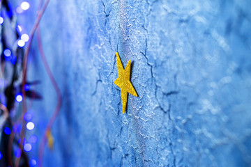 Christmas deep blue cracked background with blue highlights and garland, blurred background