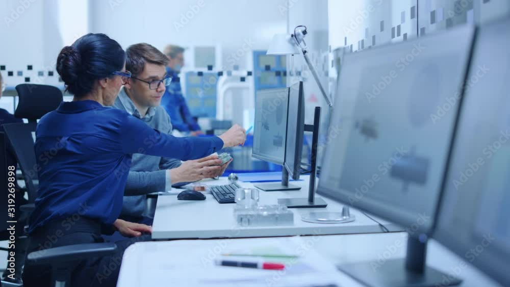 Poster modern factory: male industrial engineer explains to female project supervisor functions of the mach