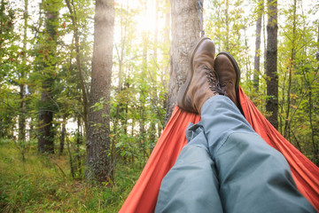 Man relaxing in camping hammock