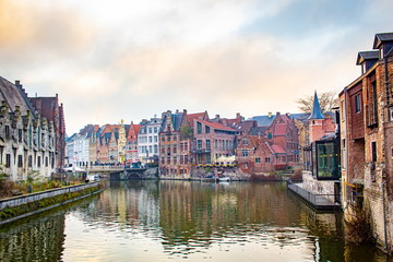 Fototapeta na wymiar A canal view and colorful architecture in Ghent Belgium on a cloudy winter December day