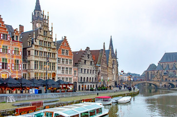 Fototapeta na wymiar A canal view and colorful architecture in Ghent Belgium on a cloudy winter December day 