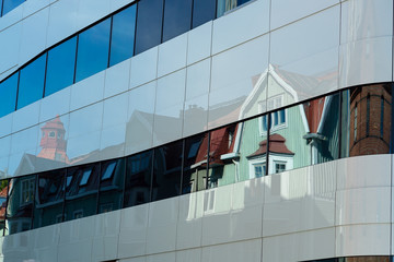 Fototapeta na wymiar Old Buildings Refleced in Modern Building in Umea, Sweden