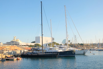 Fototapeta na wymiar Modern yachts moored in the seaport in the open air.
