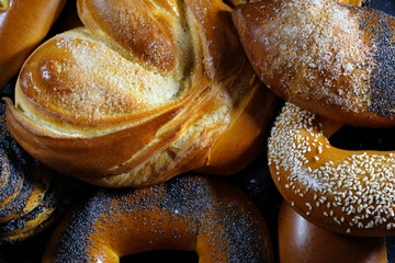 Freshly baked sweet buns or cinnamon rolls with cocoa on the table. Top view.