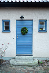 Fototapeta na wymiar Christmas Wreath on Blue Door
