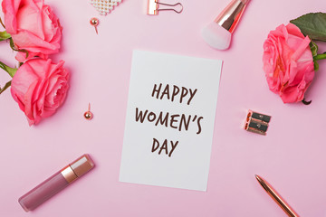 Feminine accessories and roses on pink table