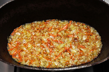 cooking pilaf in stages on a gas stove in a cauldron