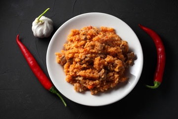 pilaf on a white plate, dark background