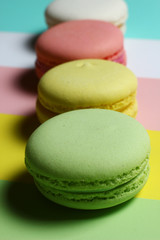 colored almond cakes on a multicolored background