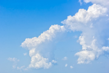 Naklejka na ściany i meble Beautiful white cumulus cloud in the blue sky, close-up