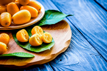 kumquat on plate at wooden table