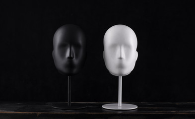 black mannequin head isolated on black background