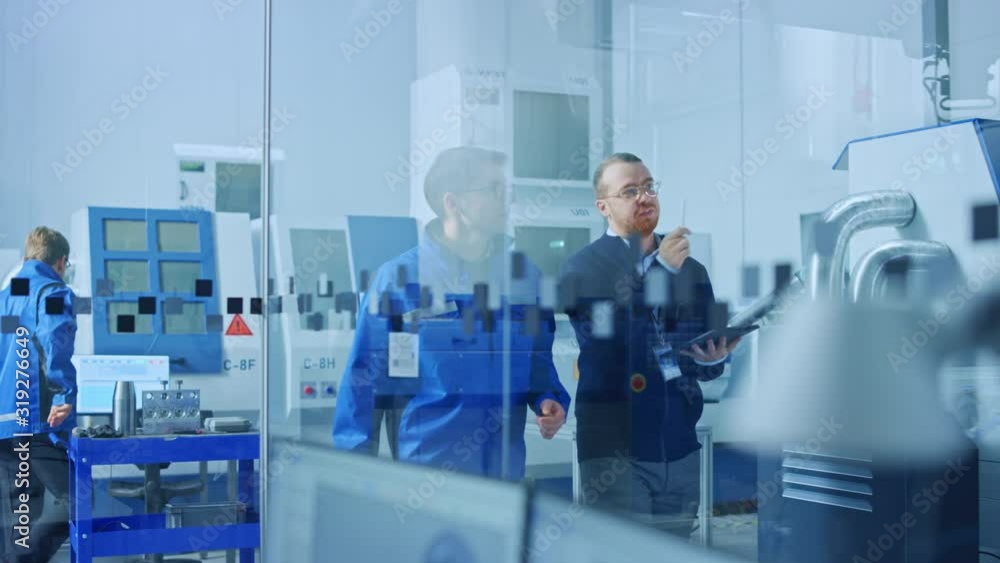 Aufkleber Modern Factory: Chief Industrial Engineer Walks with Workshop Supervisor, They Use Tablet Computer and Discuss Project Details. Manufacturing Facility with CNC Machinery and Robot Arm Assembly Line
