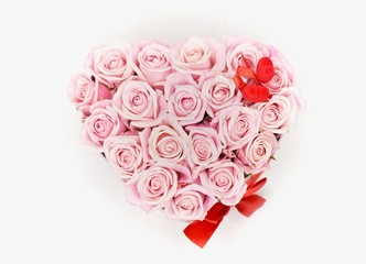 Beautiful valentiens day floral arrangement. Pink roses with read hearts flower composition in a box.