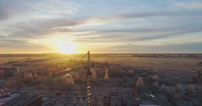 Aerial cityscape view of building construction near the hospital at sunset.