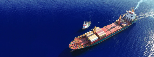 Aerial drone ultra wide top down photo of container ship cruising in Mediterranean port with deep...
