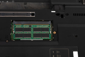 Close up of laptop memory module on slot of  motherboard. Underside of the notebook,  laptop  was produced in 2003.
