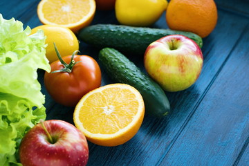 Vertical photo of fresh vegetables and fruits with calorie calculator and tape measure. Diet. Fasting. 