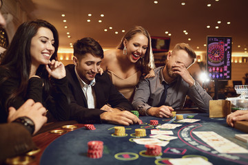 A group of wealthy young people gamble at a casino.
