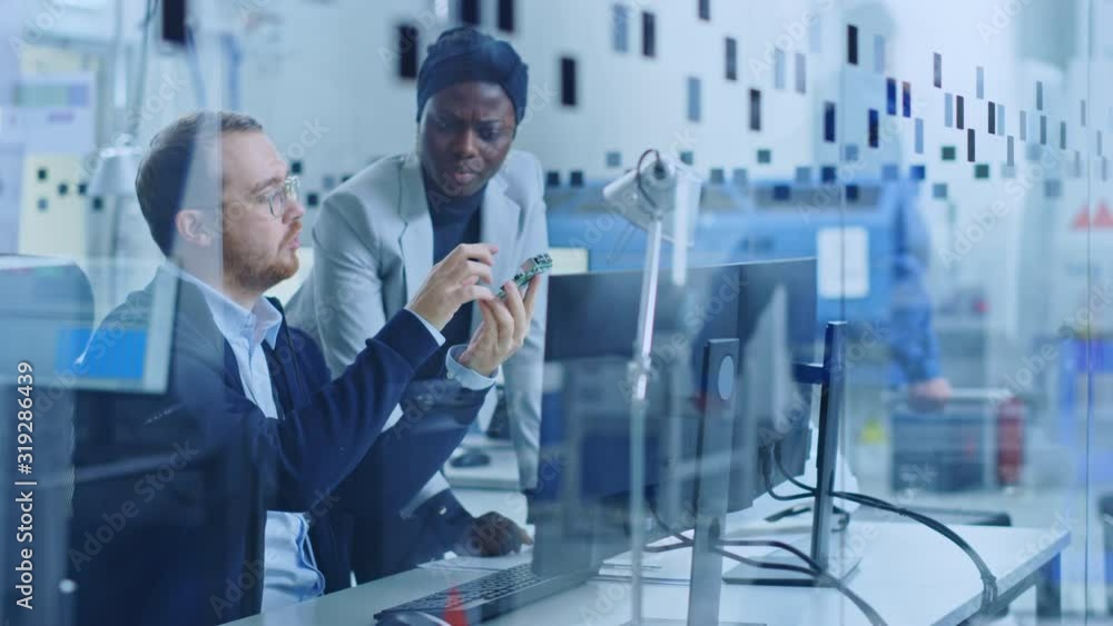 Poster modern electronic factory: female project manager talks to male electrical engineer who works on com