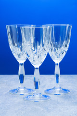 Three crystal glass with close-up on a blue background