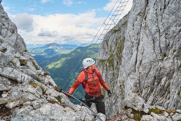 Man climbing via ferrata Intersport near Gosau, just before the well known diagonal ladder.
