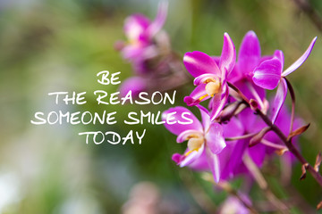 Motivation and inspirational quotes - Be the reason someone smiles today. Blurry background.