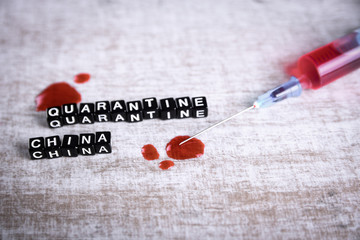 Coronavirus blood analysis concept.Wuhan, China 2020.Respiratory mask with a trace of blood, syringe and inscription quarantine.MERS-Cov.