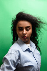 Young african woman wearing shirt over on green background thinking looking tired and bored with depression problems