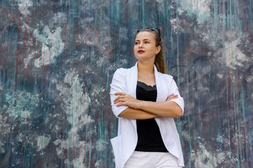 Successful business woman in white suit posing on abstract background. Woman and business