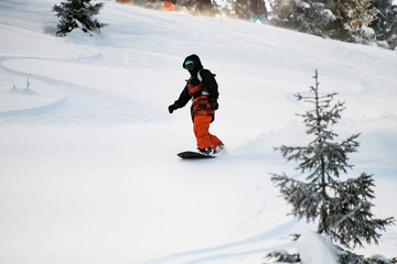 Female sliding from mountain on a professional snowboard