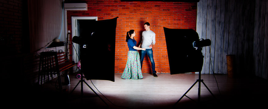 Backstage in studio of lovestory photo shot. Red brick wall