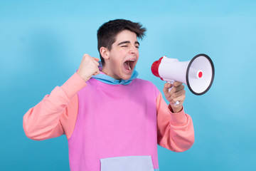 young teenage man or student with megaphone isolated on background with shout expression