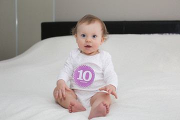 Cute 10 Month Old Baby Girl playing in Nursery room 