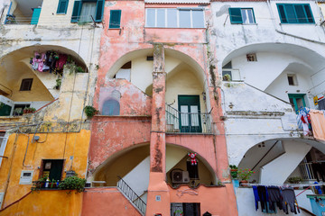 PROCIDA, ITALY - JANUARY 4, 2020 - The “Casale Vascello” is  a traditional colored courtyard surrounded by tall terraced houses in "Terra Murata", Procida.