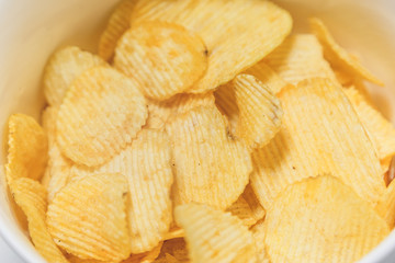 Bowl of potato chips close up view