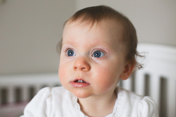 Close up Portrait of 10 Month Old Cute Baby Girl  with big Blue Eyes