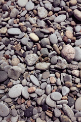 Photograph of natural rounded stones on a beach shot straight on. Good for use as a relaxing background or backdrop for any application. 
