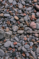 Photograph of natural rounded stones on a beach shot straight on. Good for use as a relaxing background or backdrop for any application. 
