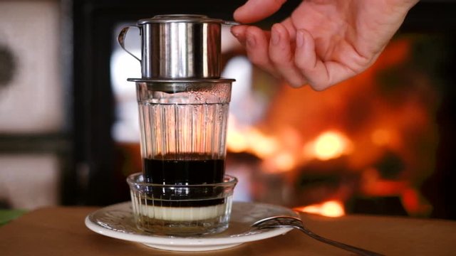 Making alternative vietnamese coffee near the fireplace