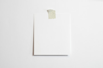 Blank polaroid photo frame with soft shadows  and scotch tape isolated on white paper background as template for graphic designers presentations, portfolios etc.