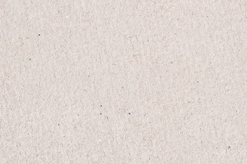 Fototapeta premium Organic cardboard texture close-up. Grunge old paper surface texture. Recyclable material, has small inclusions of cellulose, various villi, fluff