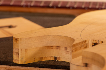 body and neck of a guitar in production
