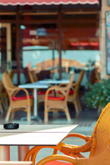 A street summer cafe with wicker chairs.