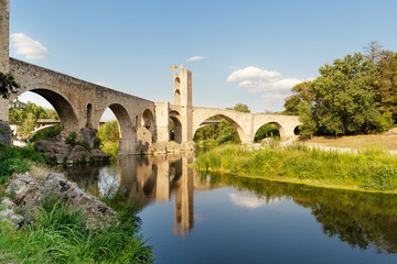 Fototapeta na wymiar View of the stone bridge over the Fluvia River in Besalu, Catalonia.