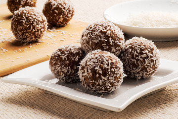Homemade raw chocolate truffles with nuts and seeds and coconut flakes