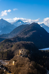 Fototapeta na wymiar Stunning view of the Bavarian Alps and Lake with the famous Hohenschwangau Castle and Alpsee lake, Schwansee lake on a sunny day in winter, Schwangau, Bavaria, Germany